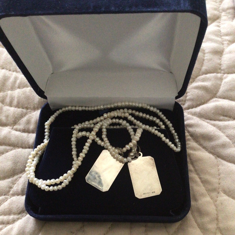 Freshwater pearls with dual silver pendants.